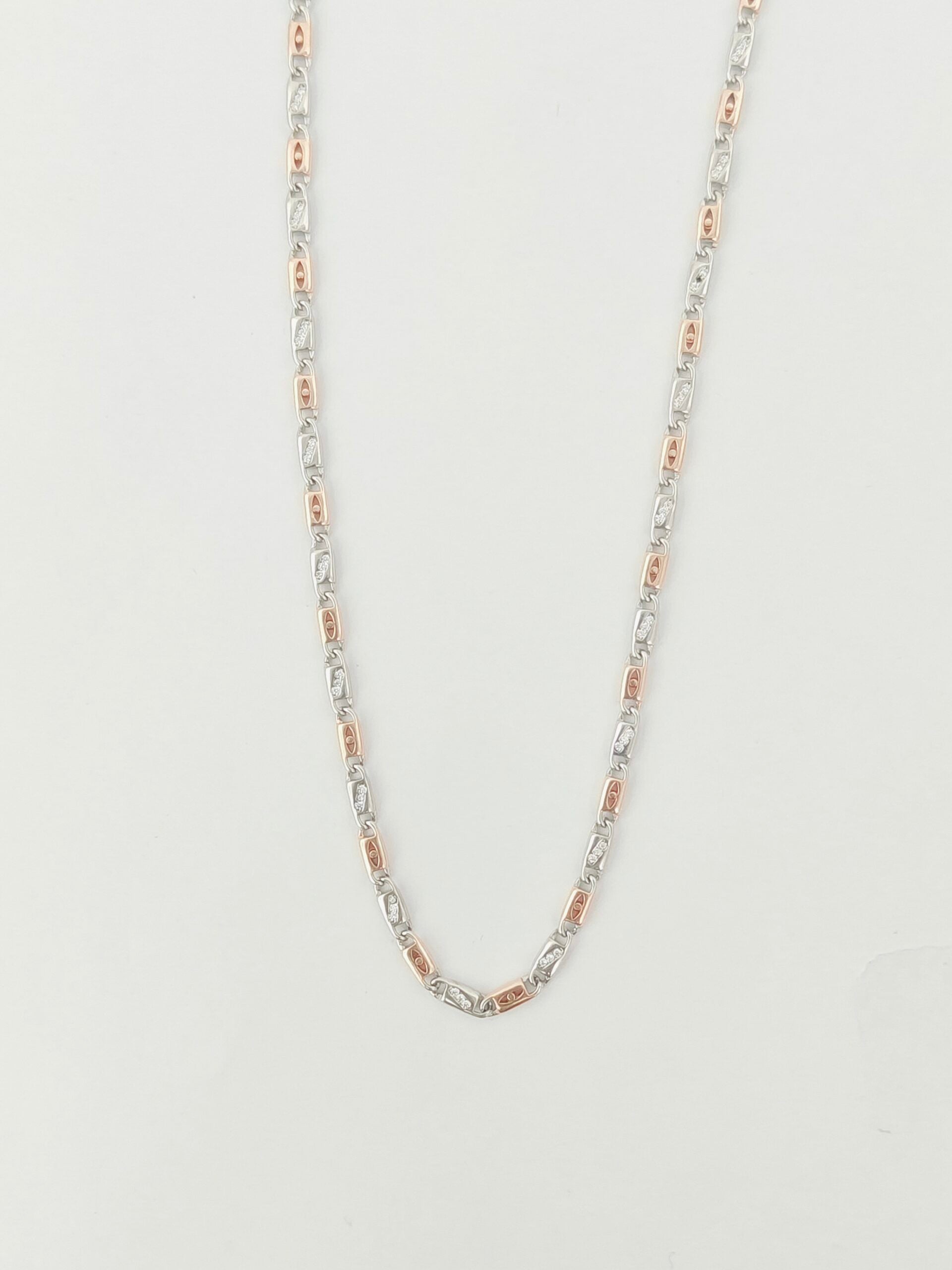 Silver chain necklace on a light gray background